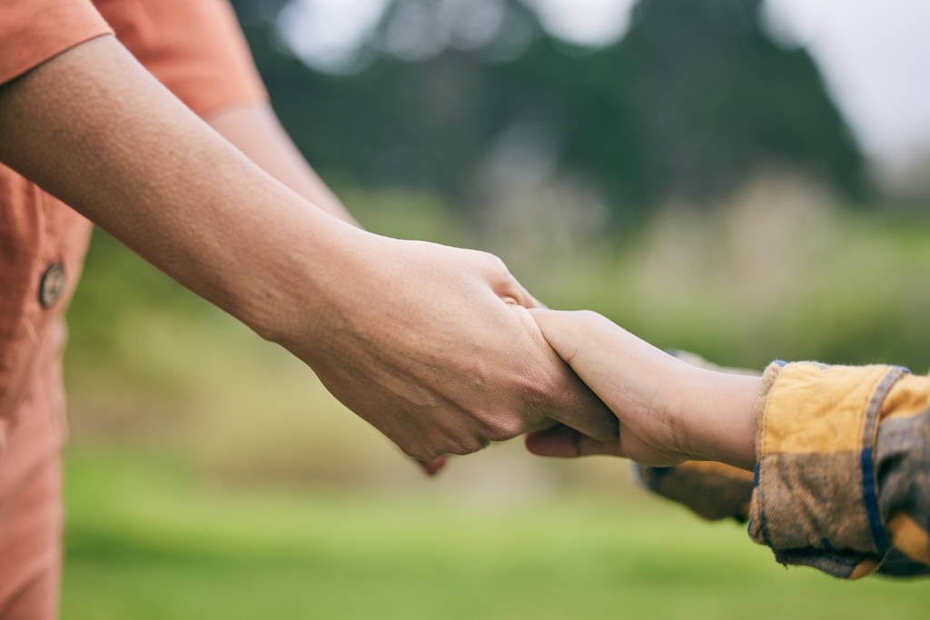 Holding hands with young child