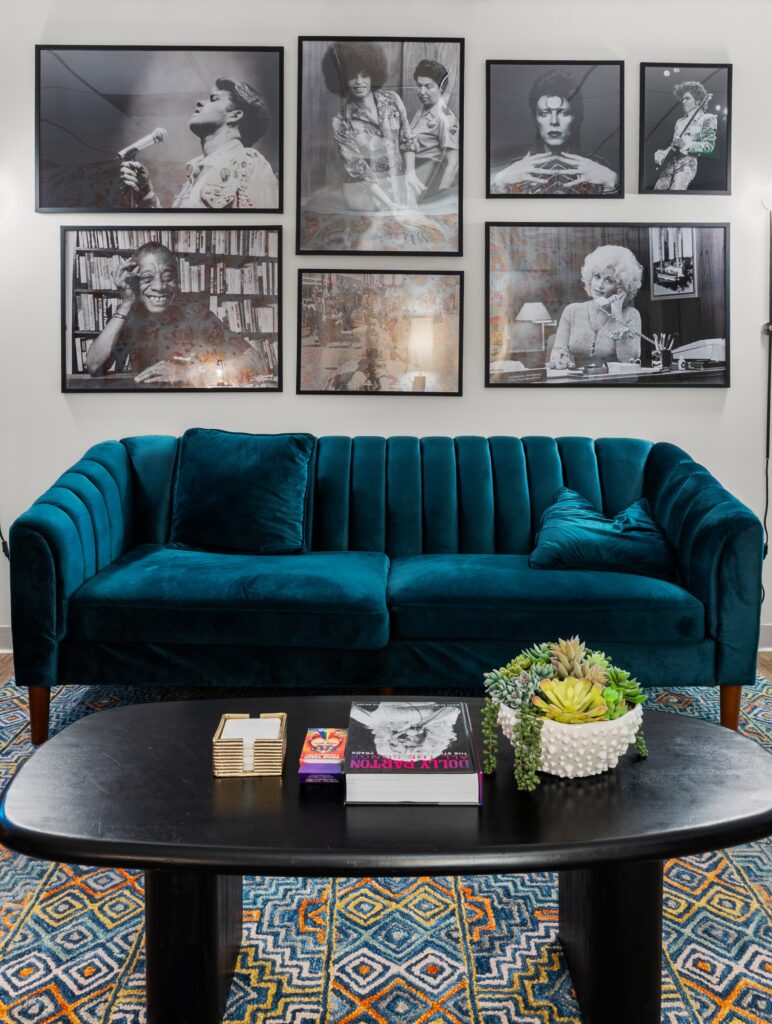 Photo of lobby, entry of Element Q Healing Center, an LGBTQ Mental Health Treatment Center in San Diego. Depicts historical figures in LGBTQ community in framed photos above a couch.