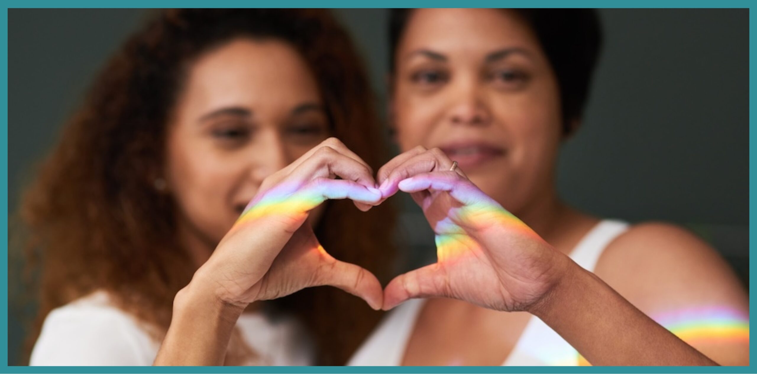 Two females holding their hands together in a heart shape, representing healing and hope