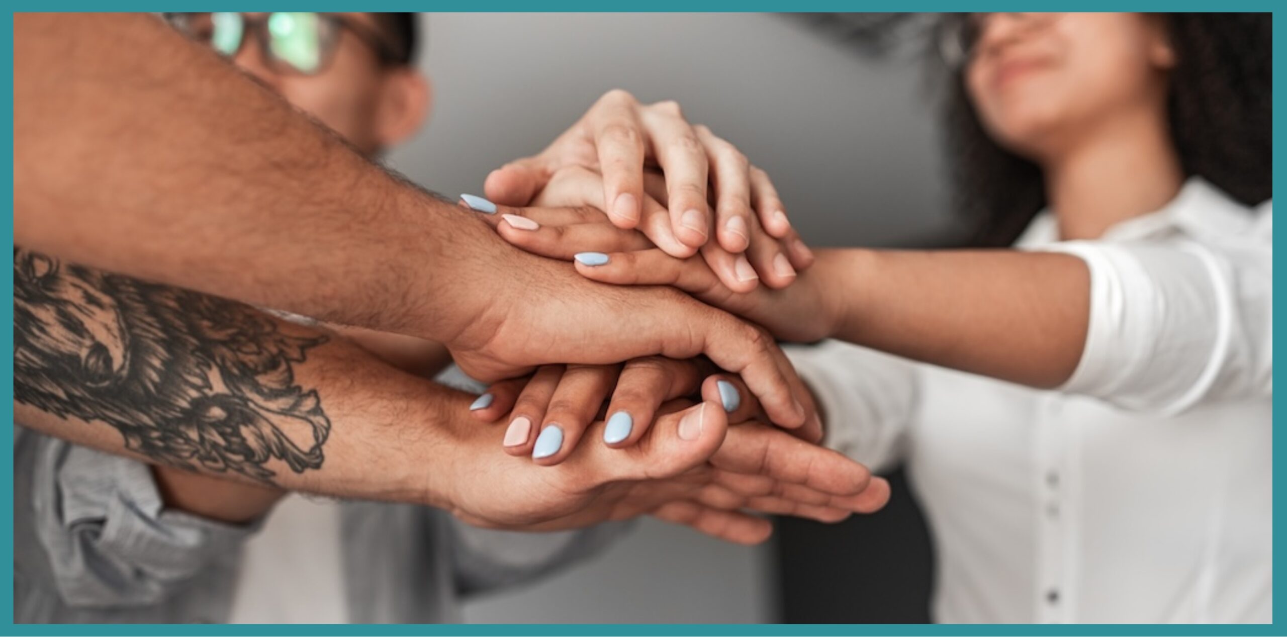 Group of people putting their hands together