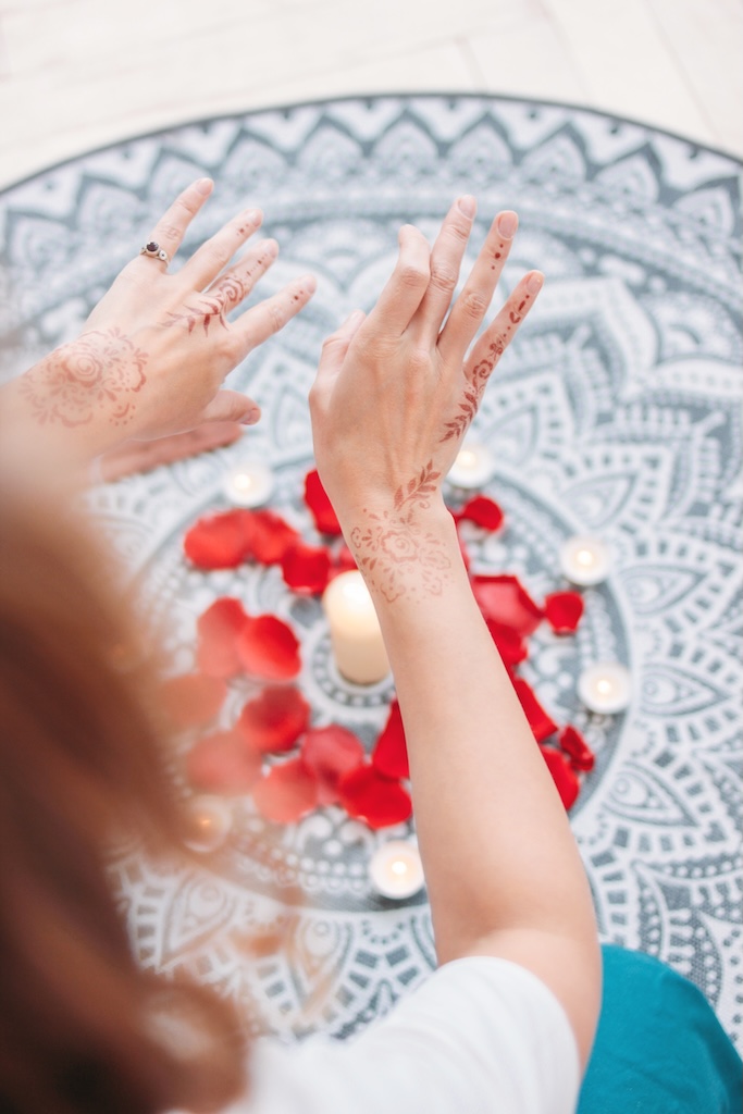Persons hands with paint on them, over candles, showing healing
