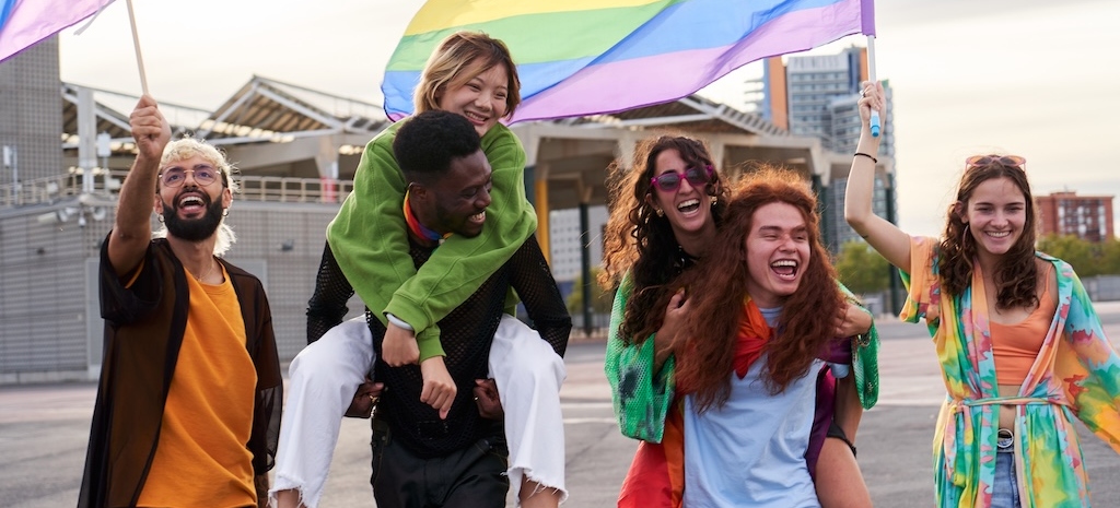 Group of friends with rainbow flags