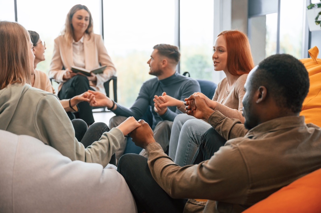 Group of people are having therapy meeting together.