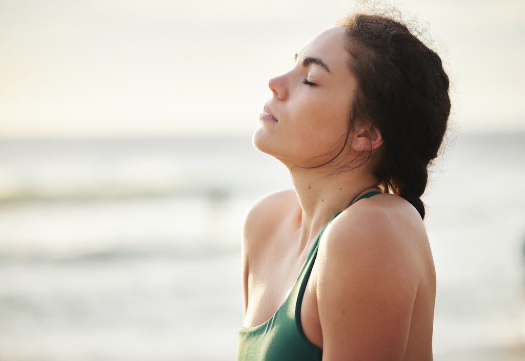 Meditate and yoga by woman at the beach, sea and ocean for calm, peace and clear mind