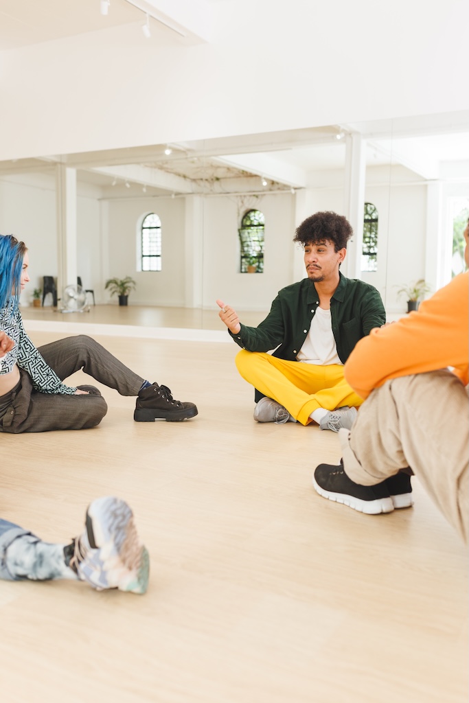 Vertical image of diverse female and male clients in group session