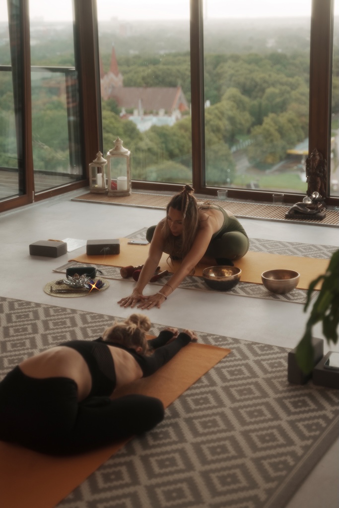 Group of women in sportswear practicing yoga and meditation