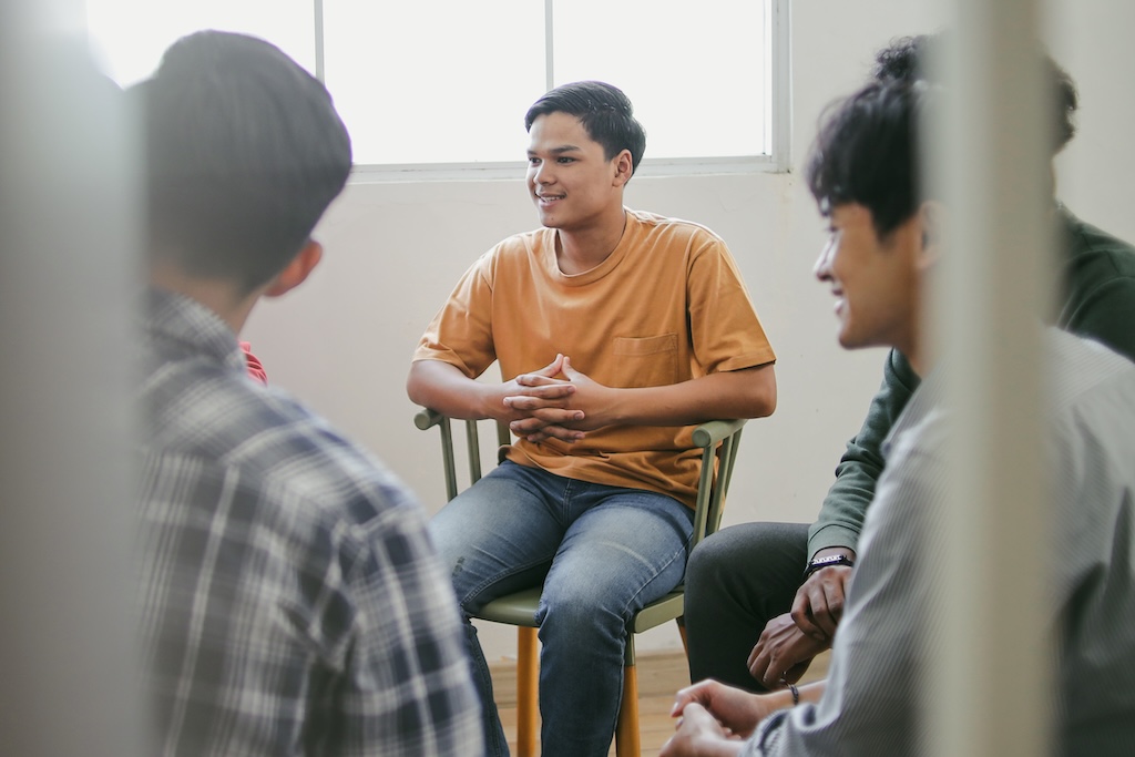 Selective Focus of Young Man Listening Carefully On Therapy Session