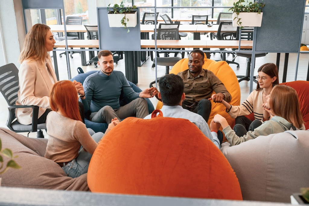 Talking, helping each other. Group of people are having therapy meeting together.