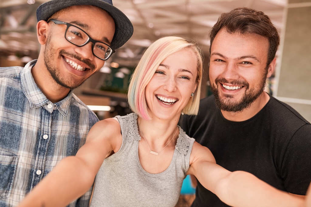 Cheerful diverse friends taking selfie