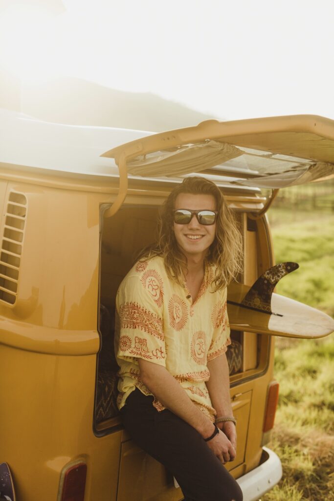 Smiling person with a van during sunset