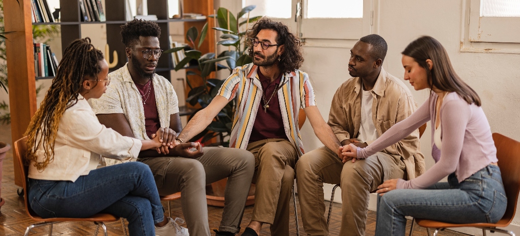 seminar talk therapy group of people sitting - diverse multiracial people talking in a group therapy, in a large room