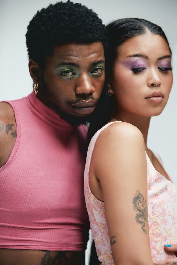 LGBTQ+ man and woman wearing makeup, posing for photo, representing the diverse population we are proud to serve at Element Q