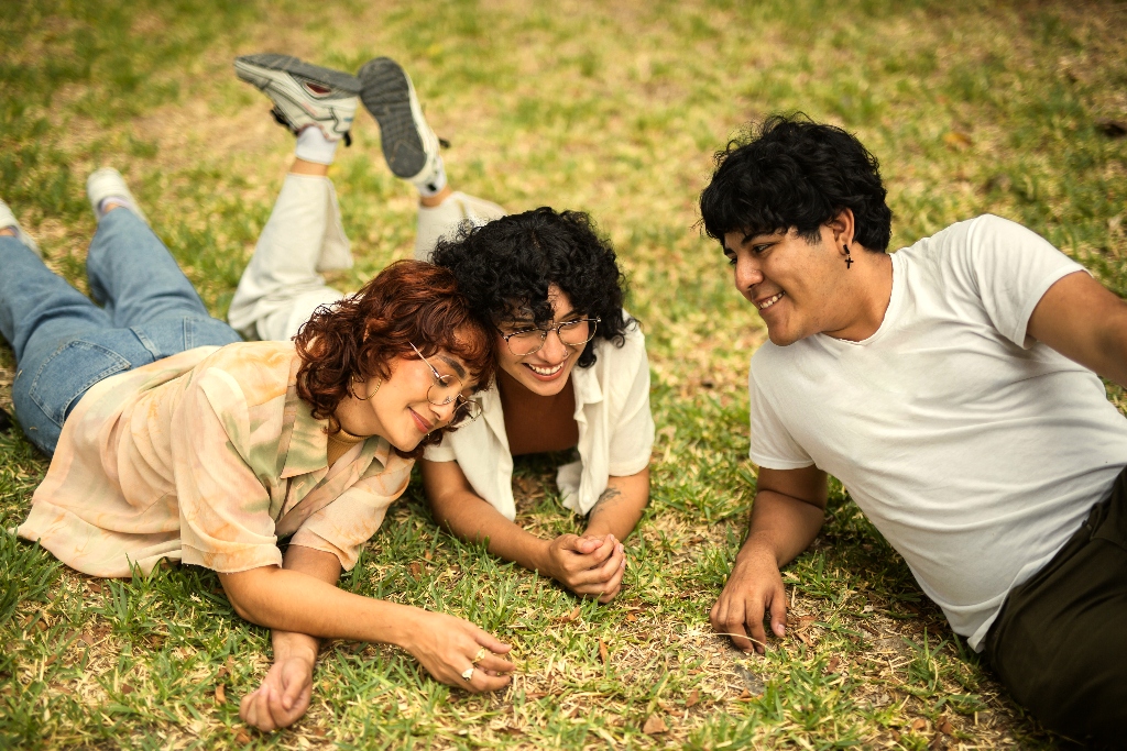 LGBTQ+ individuals relaxing together outdoors in San Diego, representing supportive community at an addiction treatment center