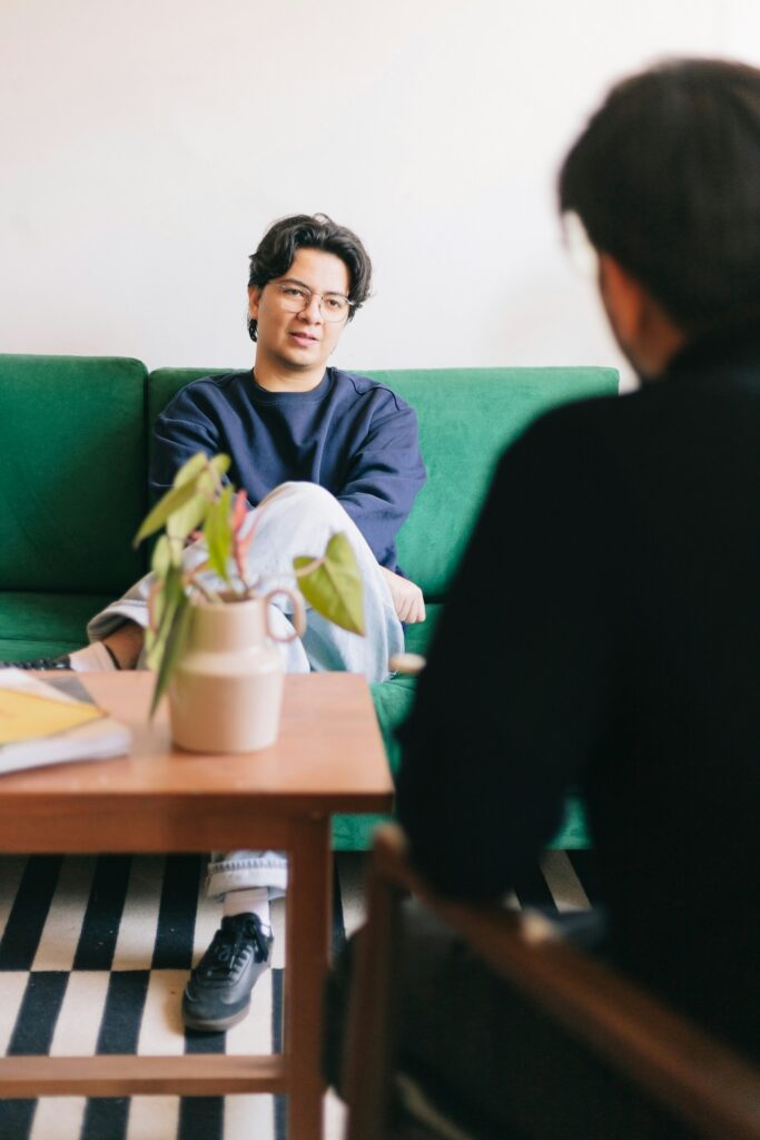 Client in one-on-one therapy session discussing substance use concerns with clinician in a supportive, affirming setting for meth addiction treatment and outpatient care (PHP/IOP)
