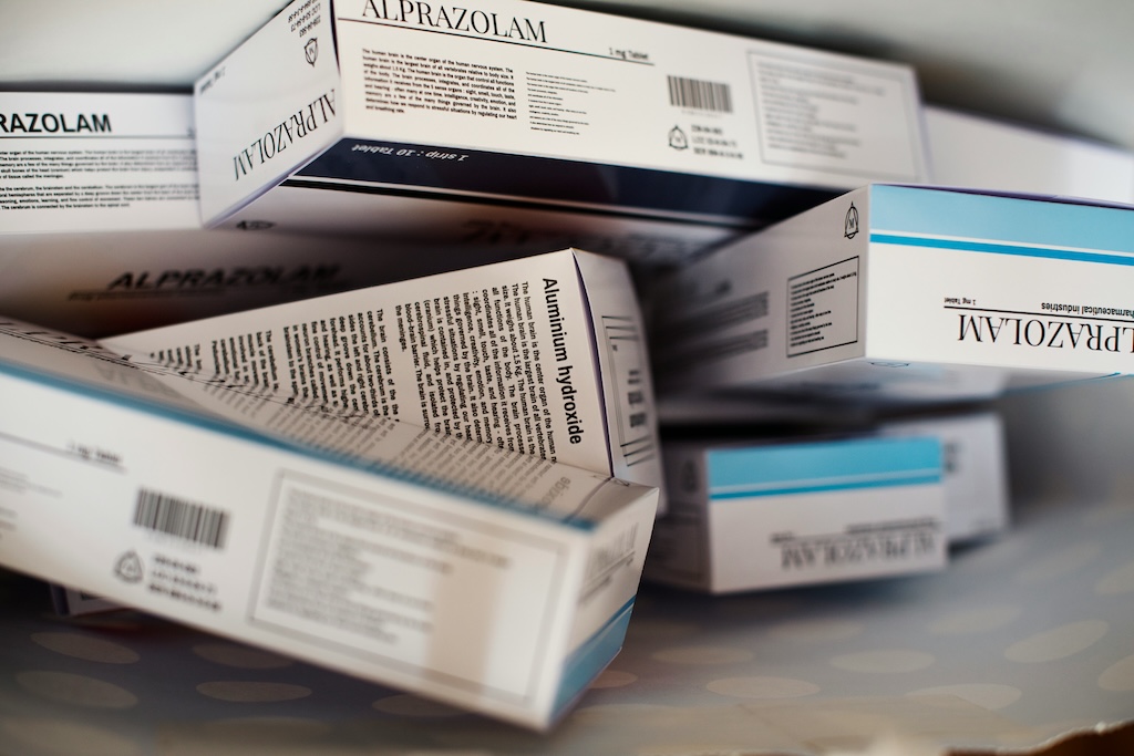 Boxes of alprazolam medication scattered across a surface, representing benzodiazepine use and addiction treatment context