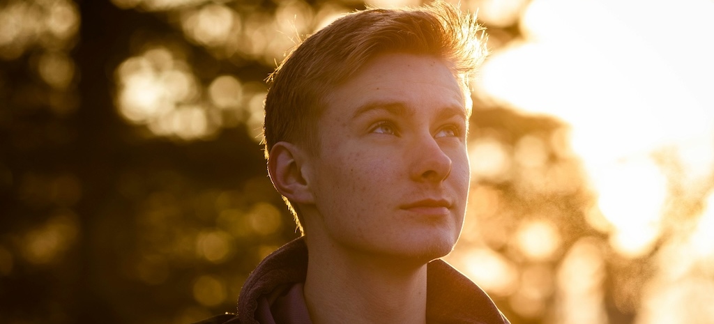 Person looking upward in reflective light, representing self-awareness and emotional clarity when recognizing signs of a toxic relationship