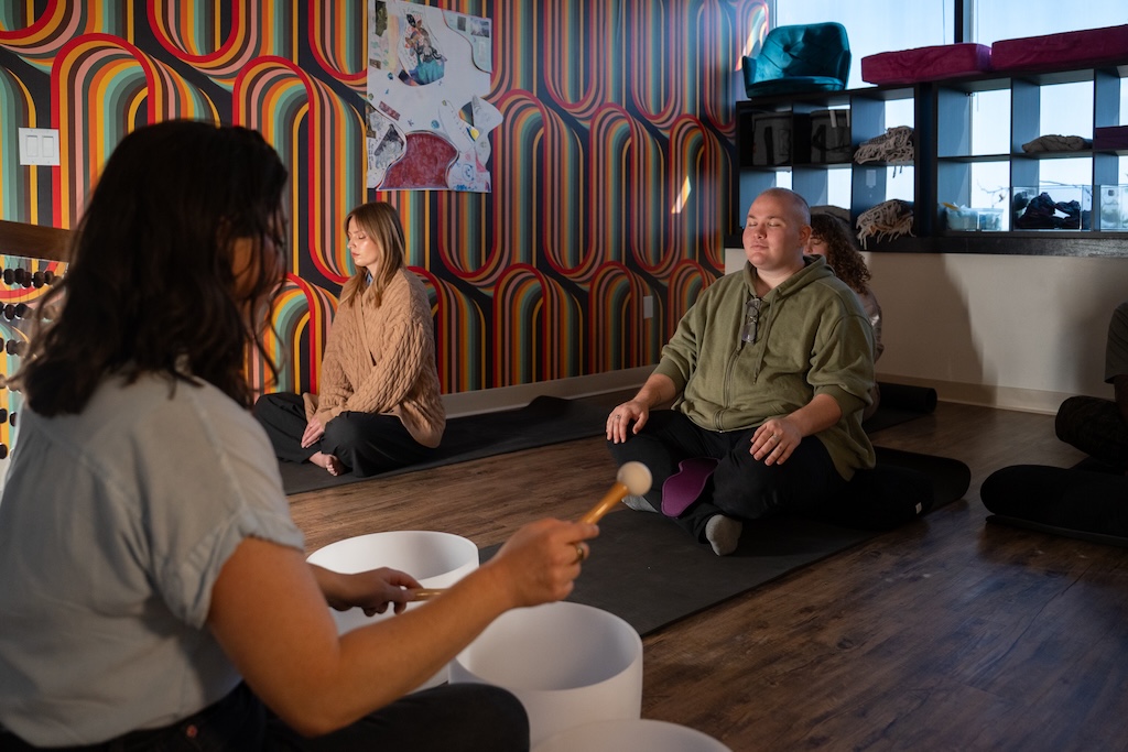 Sound healing facilitator leading a mindfulness group session as part of holistic mental health treatment at Element Q Healing Center.