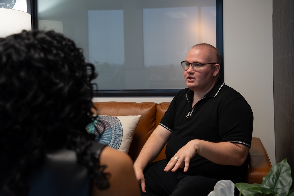 Client sharing their experiences during an individual therapy session at Element Q Healing Center, reflecting LGBTQIA+ affirming and trauma-informed mental health care.