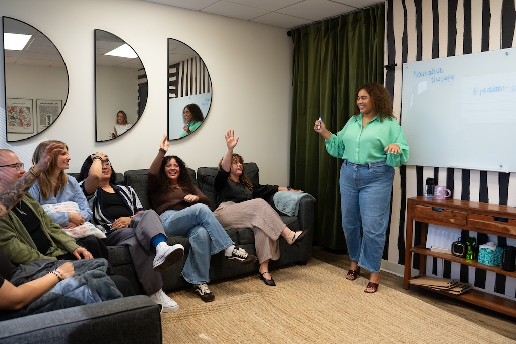Clinician leading a group therapy session at Element Q Healing Center, fostering connection, engagement, and peer support in treatment.