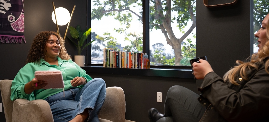 Client and clinician seated together in a counseling session at Element Q Healing Center, discussing addiction recovery and mental health treatment in a welcoming office setting.
