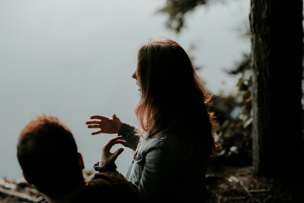 Two people communicating outdoors, illustrating the double empathy problem between autistic and non-autistic people.