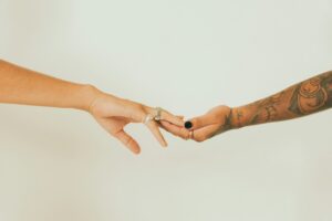 Two people reaching toward each other, illustrating connection and relationship anarchy.